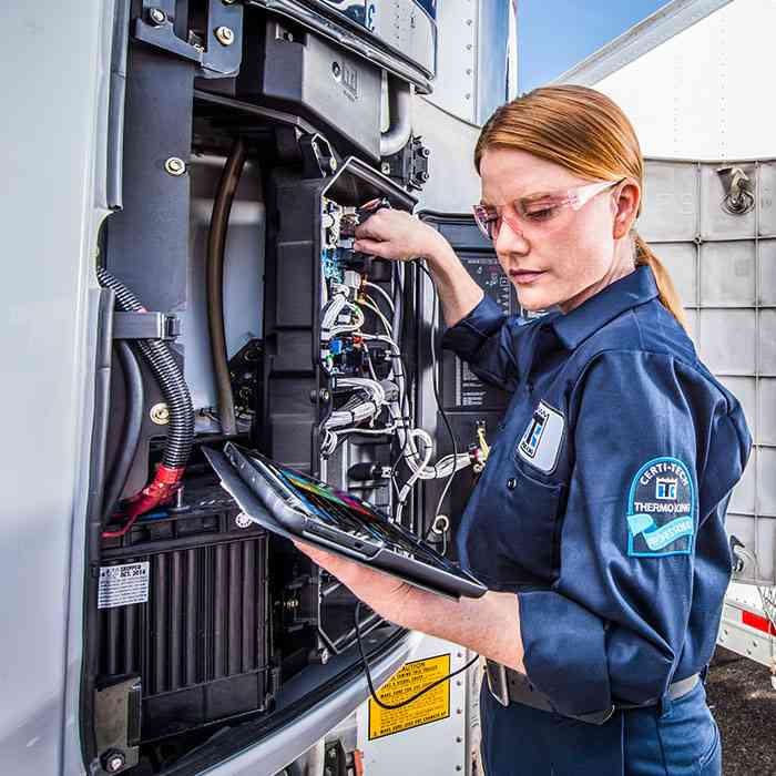 female maintenance technician working on a Thermo King unit